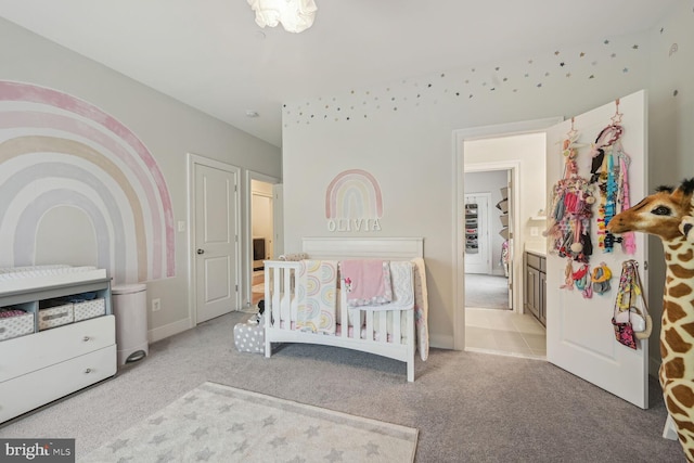 carpeted bedroom with a nursery area