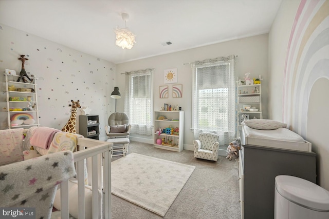 bedroom with carpet floors and a nursery area