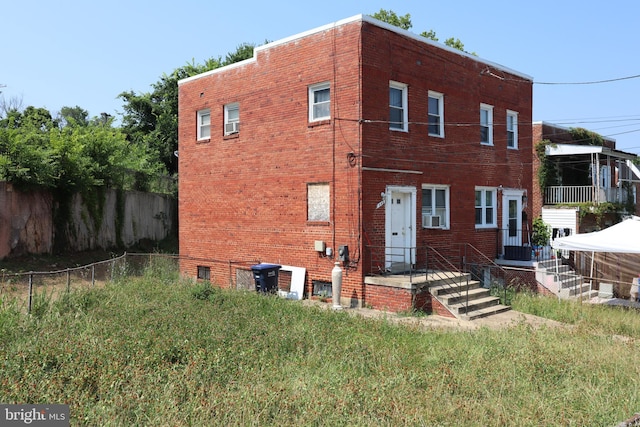 exterior space with brick siding and fence