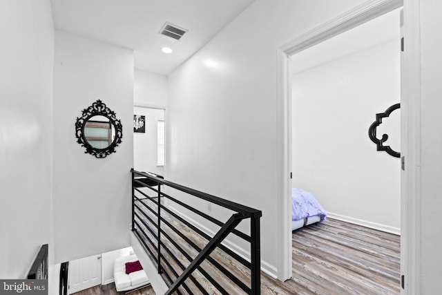 corridor with hardwood / wood-style floors