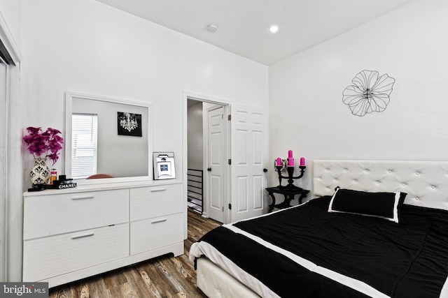 bedroom with dark hardwood / wood-style flooring