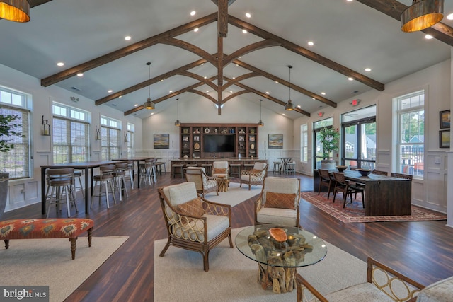 living room with beam ceiling, ceiling fan, and high vaulted ceiling