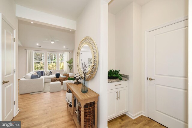 hall with light hardwood / wood-style floors