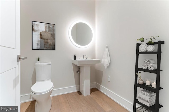 bathroom with wood-type flooring and toilet