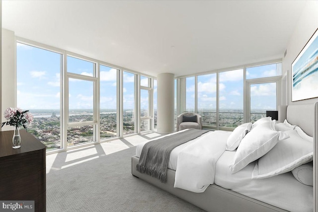 bedroom featuring multiple windows, light colored carpet, and floor to ceiling windows