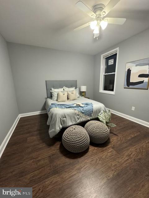 bedroom with dark hardwood / wood-style floors and ceiling fan