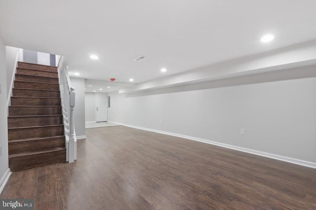 basement featuring dark hardwood / wood-style flooring