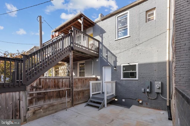 back of house featuring a patio and a wooden deck