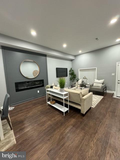 living room featuring dark wood-type flooring