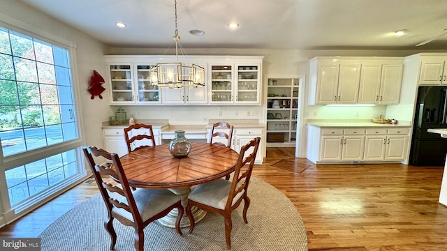 dining room featuring light hardwood / wood-style floors and a notable chandelier