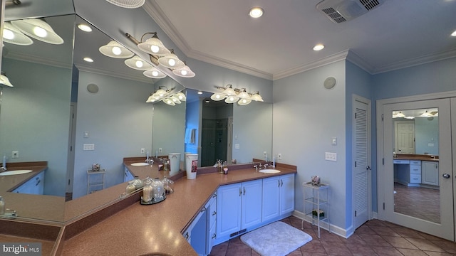 bathroom with vanity, ornamental molding, and tile patterned flooring