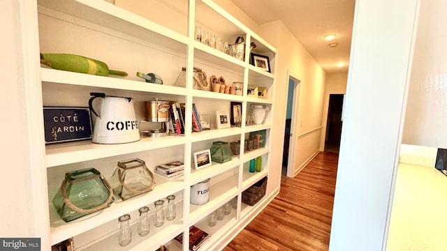 hallway with hardwood / wood-style floors