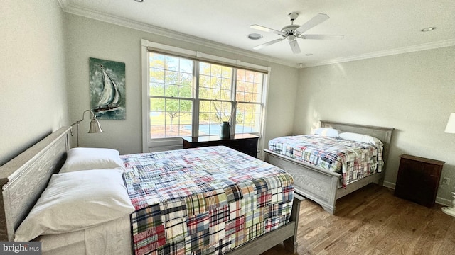 bedroom with ornamental molding, hardwood / wood-style floors, and ceiling fan