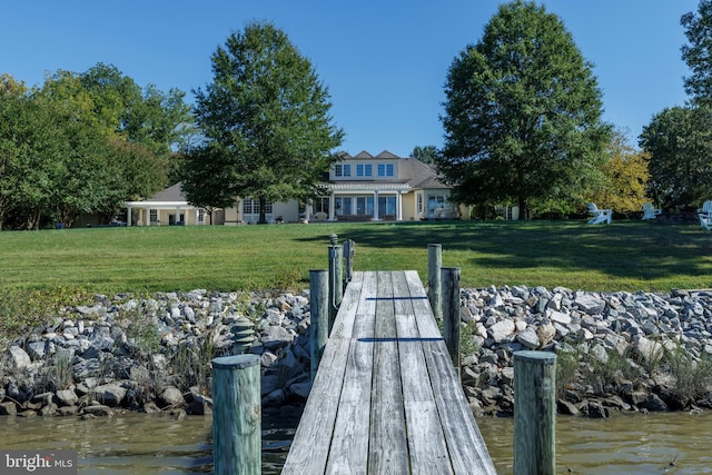 dock area featuring a water view and a yard