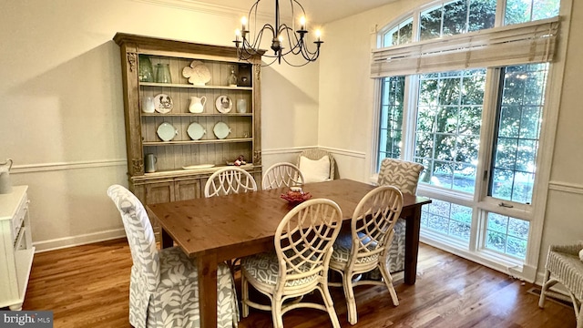 dining room featuring a notable chandelier and dark wood-type flooring