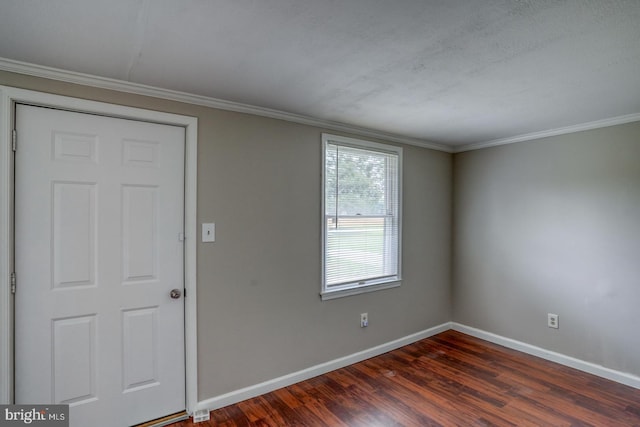 foyer with dark wood-type flooring and ornamental molding