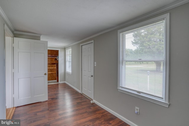 entryway with dark hardwood / wood-style floors and ornamental molding