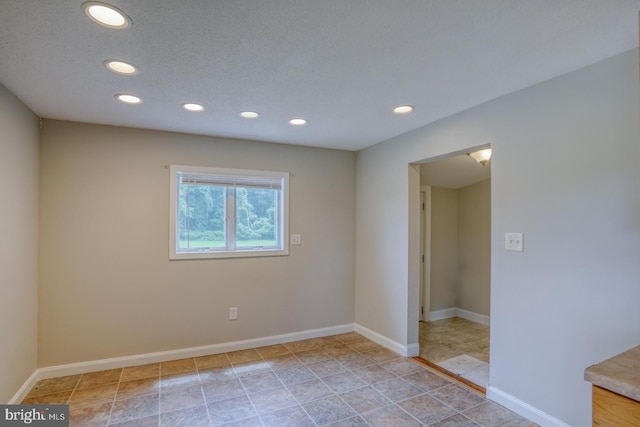 spare room featuring a textured ceiling