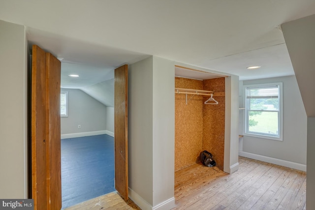 interior space with lofted ceiling and light wood-type flooring