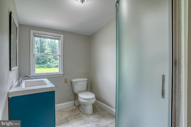 bathroom featuring toilet and vanity