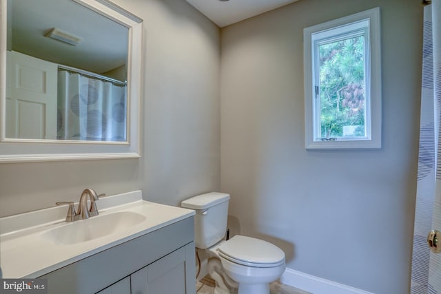 bathroom featuring toilet and vanity