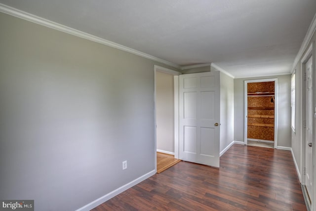 spare room with built in features, dark hardwood / wood-style flooring, and ornamental molding