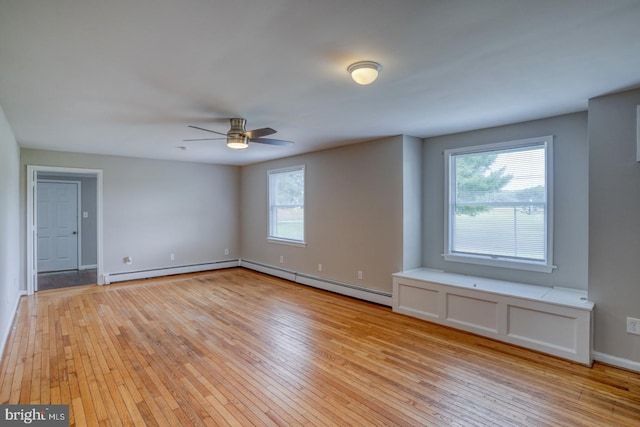 unfurnished room with ceiling fan, a baseboard heating unit, and light hardwood / wood-style flooring