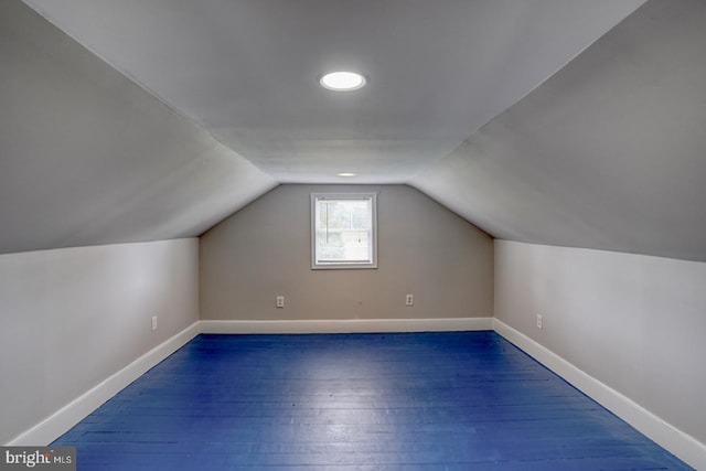 additional living space featuring dark hardwood / wood-style flooring and lofted ceiling