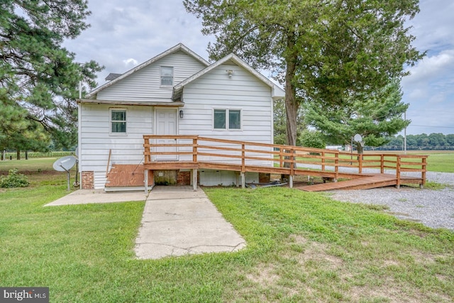 rear view of property with a yard, a patio area, and a deck