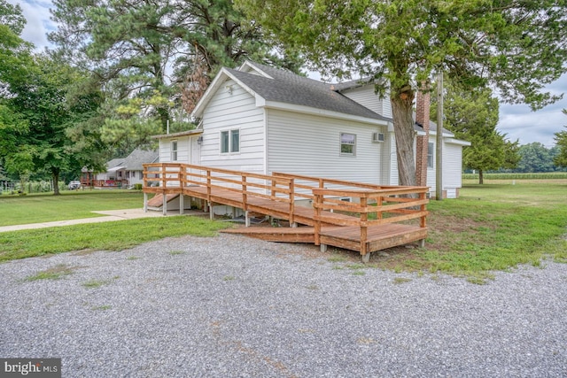 exterior space featuring a deck and a lawn