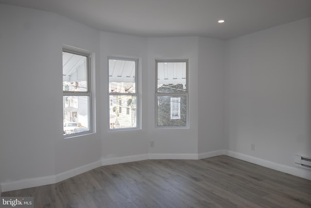 empty room with dark hardwood / wood-style flooring