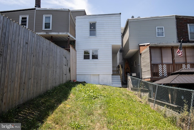 rear view of house with a yard