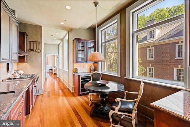 sitting room featuring wine cooler and light hardwood / wood-style flooring