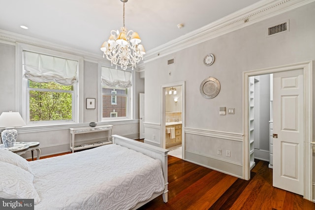 bedroom featuring ornamental molding, connected bathroom, dark wood-type flooring, and a notable chandelier