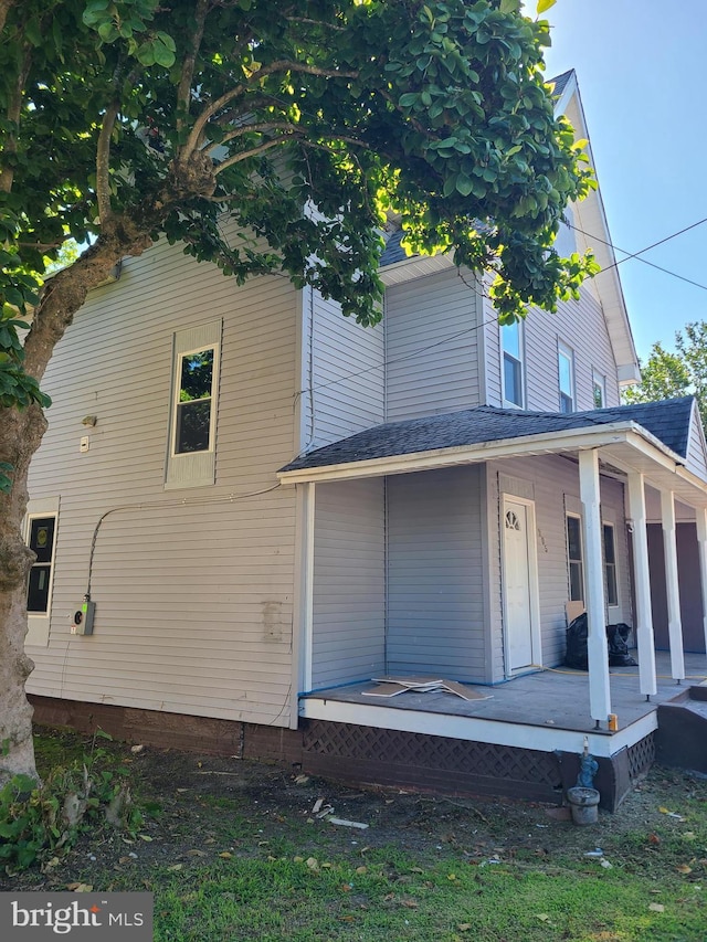 back of property featuring a porch