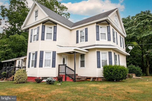 victorian home with a front lawn