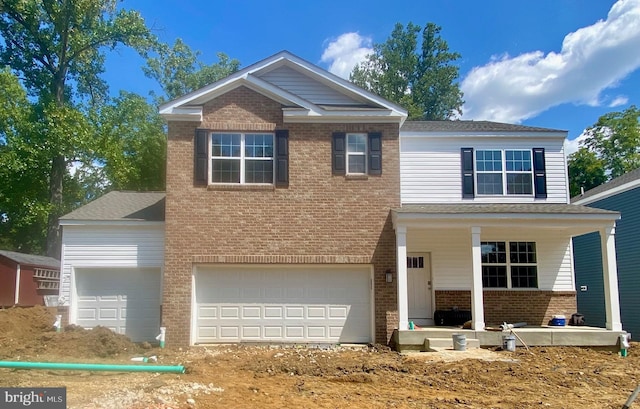 view of front of property featuring a porch and a garage