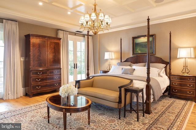 bedroom with french doors, ornamental molding, coffered ceiling, light hardwood / wood-style flooring, and a chandelier