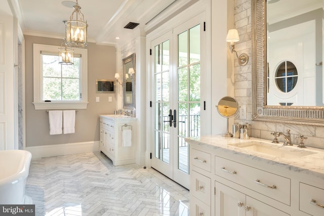 entryway featuring ornamental molding, sink, and french doors