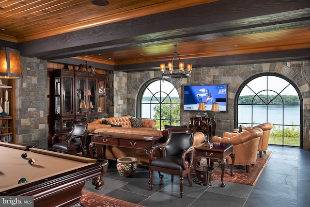 game room with wooden ceiling, billiards, a wealth of natural light, beam ceiling, and a chandelier