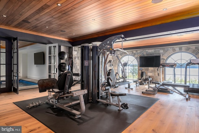 exercise room featuring french doors, wooden ceiling, and wood-type flooring