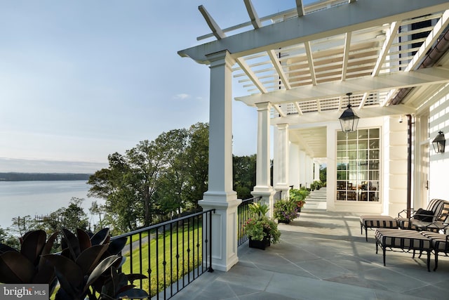 view of patio / terrace with a water view and a pergola