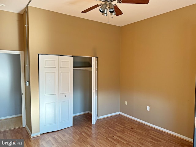 unfurnished bedroom featuring ceiling fan, a closet, and light hardwood / wood-style floors