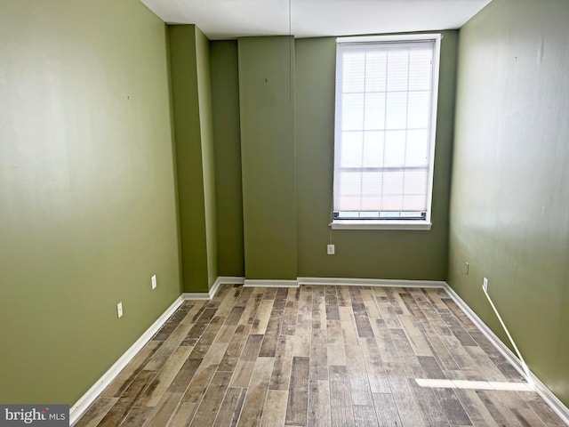 unfurnished room with hardwood / wood-style floors