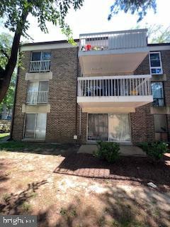 rear view of property featuring a balcony