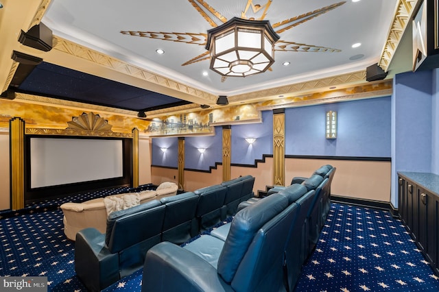 carpeted home theater room featuring ornamental molding