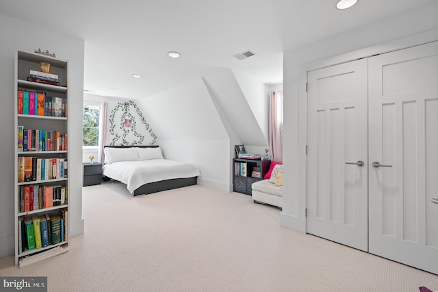 carpeted bedroom with lofted ceiling