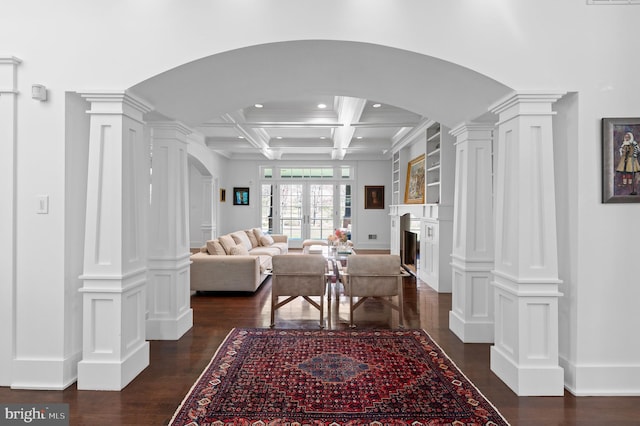 living room with ornate columns, french doors, coffered ceiling, dark hardwood / wood-style flooring, and beamed ceiling