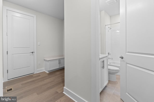 full bathroom featuring vanity, hardwood / wood-style floors, shower / bathing tub combination, and toilet