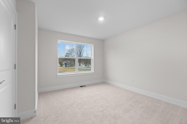 unfurnished room with light colored carpet